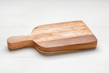 Cutting board on white wooden background