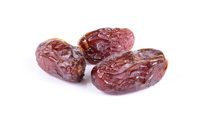 Medjool dried date palm fruits isolated on a white background.