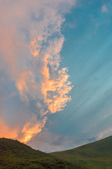 Beautiful colorful summer sunset over Carpathian mountain hills