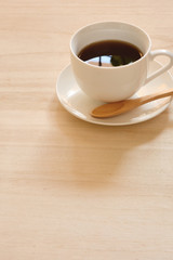 A cup of coffee on a wood table