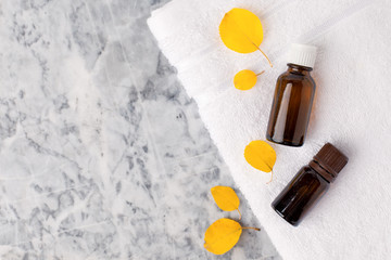 Seasonal Spa set Massage essential oils, towels on gray marble plate, organic cosmetic products, aromatherapy and alternative medicine concept, spa salon banner, flyer, coupon