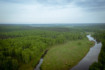 Morning in nature with a river, fields, trees. Aerial view.