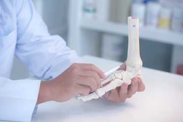 Orthopedic doctor in his office with the patient and the foot model orthopedic doctor in his office...