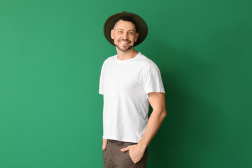 Fototapeta premium Man in stylish t-shirt on color background