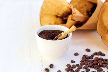Recycling waste from coffee. Body scrub of ground coffee, homemade cosmetic for peeling and spa care on white background. Zero waste, eco friendly, reasonable consumption concept.