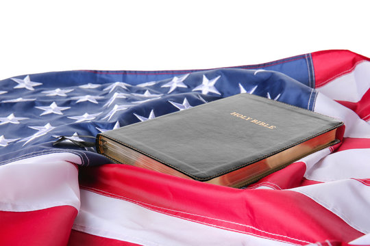 Holy Bible and USA flag on white background