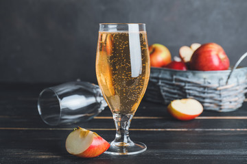 Glass of apple cider on dark background