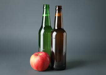 Bottles of apple cider on grey background