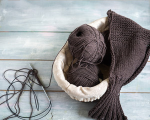 Hobby homework. Knitting sweaters made of brown cotton yarn. Balls of yarn and circular knitting...