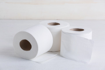 Rolls of toilet paper on table