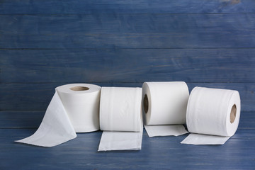 Rolls of toilet paper on wooden background