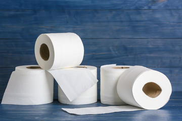 Rolls of toilet paper on wooden background
