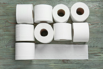 Rolls of toilet paper on wooden background