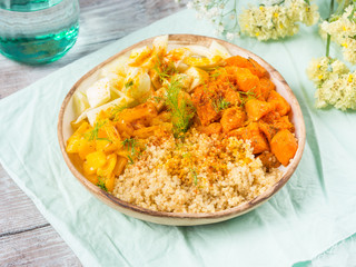 Vegan quinoa bowl with baked spiced pumpkin, fennel, bell pepper and turmeric. Healthy gluten free lunch or dinner