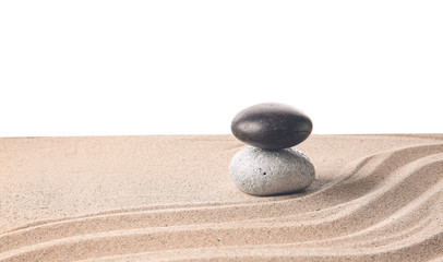 Fototapeta na wymiar Stones on sand with lines against white background. Zen concept