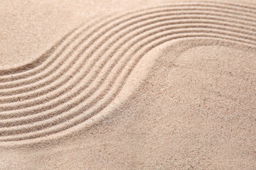 Fototapeta na wymiar Texture of sand with lines. Zen concept