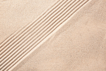 Fototapeta na wymiar Texture of sand with lines. Zen concept