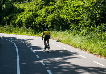 Cyclist riding bicycle on cycling trail path