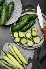 Composition with fresh green cucumbers on table