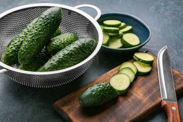 Composition with fresh green cucumbers on table