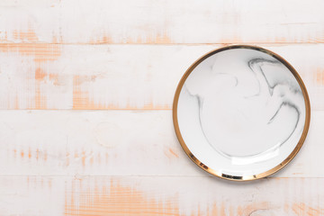 Ceramic plate on wooden background