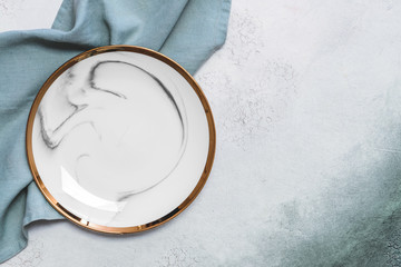 Ceramic plate and napkin on color background