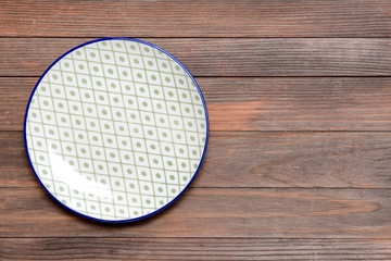 Ceramic plate on wooden background