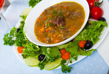 Delicious cooked goulash from chicken hearts served with  vegetables