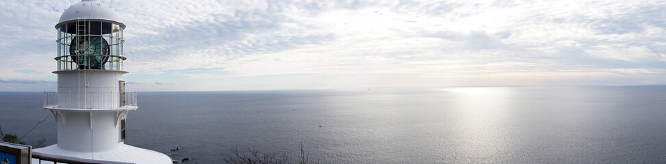 Fototapeta premium Panoramic photo of the lighthouse and the sea at dusk
