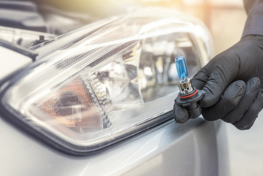 Repair Man Hand Installing Halogen Led Bulb For Car Headlights