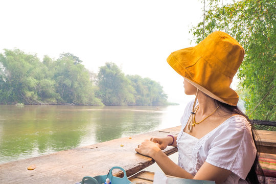 Woman Wearing A Yellow Hat On The Waterfront