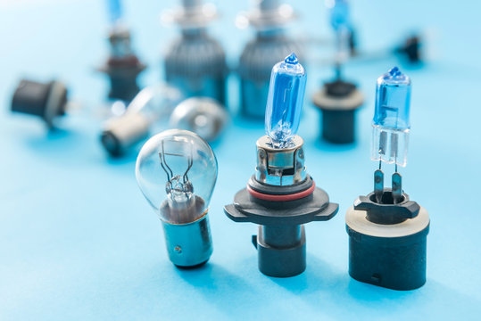 Different halogen auto bulb Isolated on blue background. Car light lamp for use in illumination when moving.