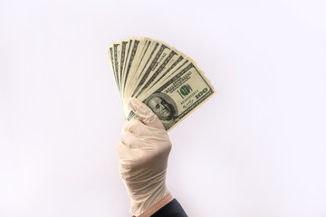 male hand give dollar to pay in protective gloves  for safety isolated on white background