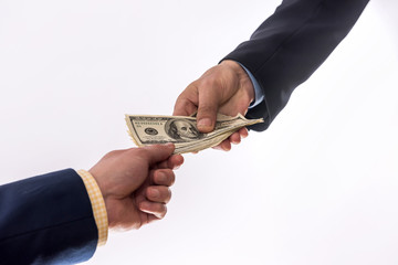Transfer of money between two businessmen. Male's hand giving 100 dollar isolated on gray