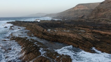 Walkuing along the coast contempalting the wonders of nature with its natural swimming pools and its ocean