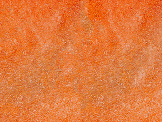 Orange stucco texture. Orange rough surface. Selective focus