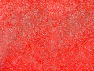 Red stucco texture. Red rough surface. Selective focus
