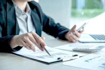 business man is sitting at a desk and calculating financial graph that show results