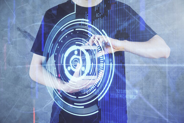 Fototapeta premium Double exposure of man's hand holding and using a digital device and data theme hologram drawing. Technology concept.
