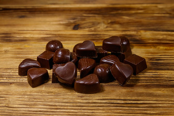 Tasty chocolate candies on wooden table