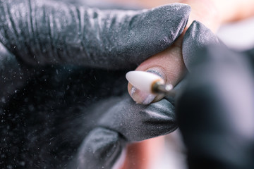 Close-up of hardware milling cutter for removing gel polish. Apparatus manicure in beauty salon....