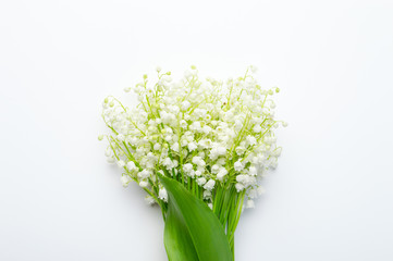 Beautiful bouquet of lilies of the valley on a white background, top view