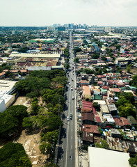 Las Pinas, Metro manila - May 2020: Aerial of Alabang Zapote Road in center, with Alabang skyline...