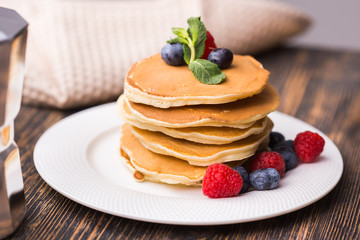 Close-up delicious pancakes with fresh blueberries and raspberries.