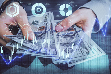 Multi exposure of financial graph drawing hologram and USA dollars bills and man hands. Analysis concept.
