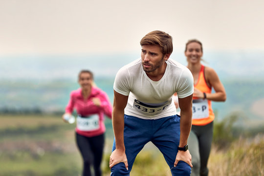 Young Marathon Runner Catching Breath After The Race In Nature.