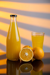 Bottle of orange juice and oranges