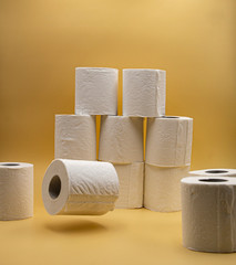 White toilet paper for the bathroom with yellow background
