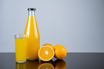 Bottle of orange juice and oranges