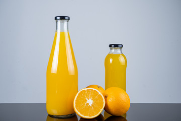 Bottle of orange juice and oranges